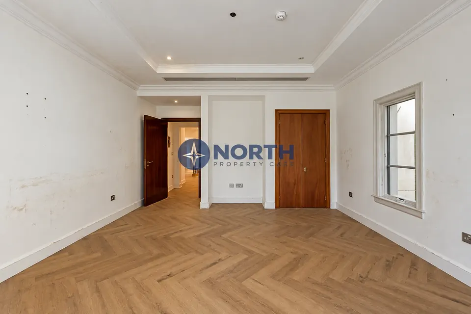 Bedroom with marked walls before the refresh