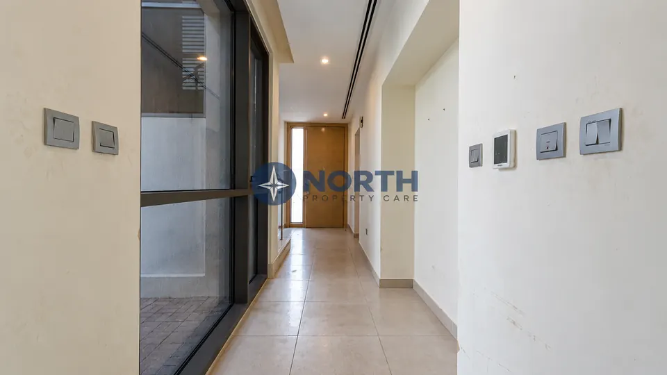 Villa hallway with scuff marks before painting