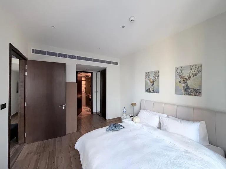 Bedroom with plain white walls before wall painting in the Jumeirah Beach Residence apartment