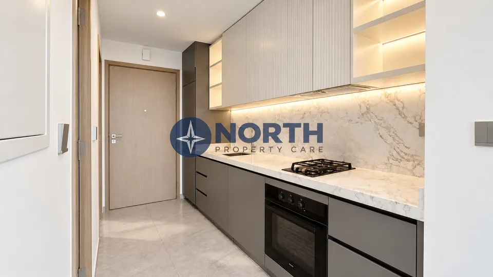 Kitchen facing entrance after same-colour internal wall painting at Peninsula Four