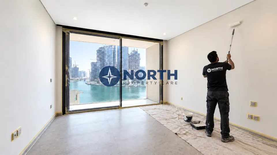 Protected main-room floor during roller application to the studio walls