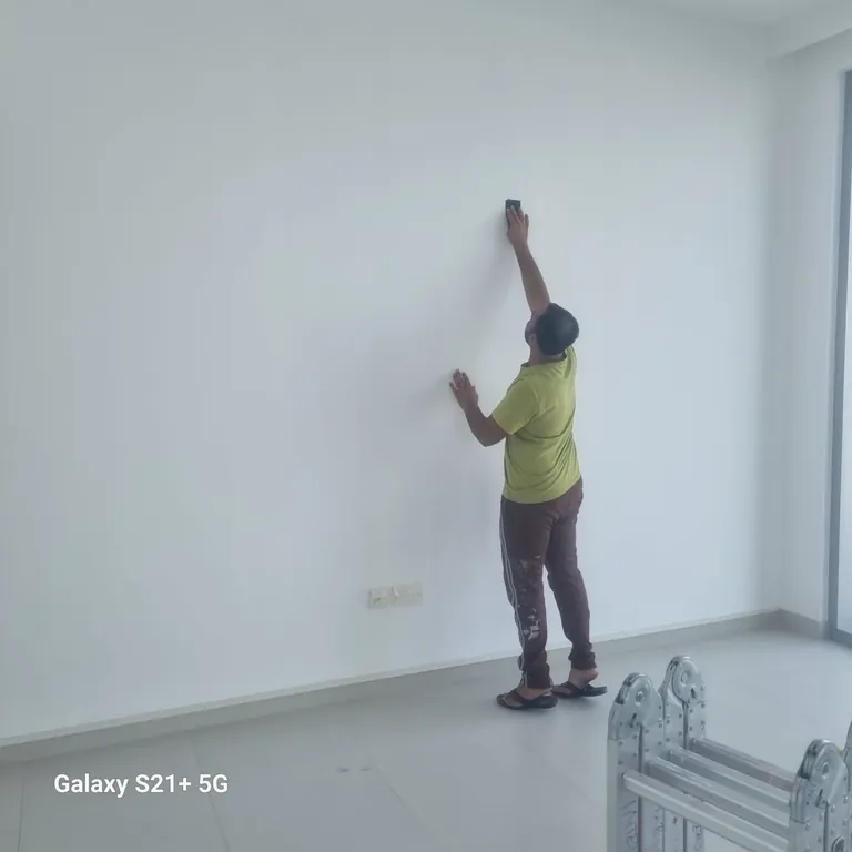 North Property Care team member preparing a wall for painting in Dubai Creek Harbour