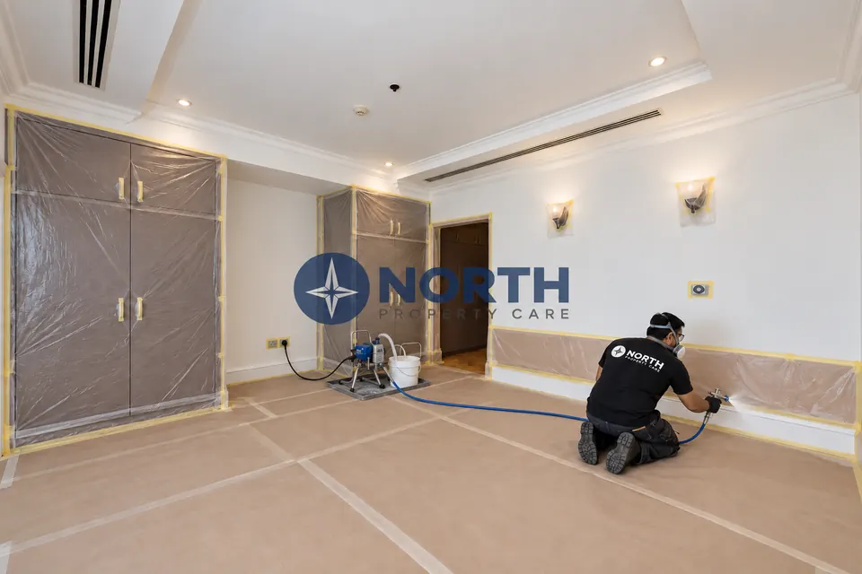 Floors and walls masked before indoor spray painting of skirting and architraves