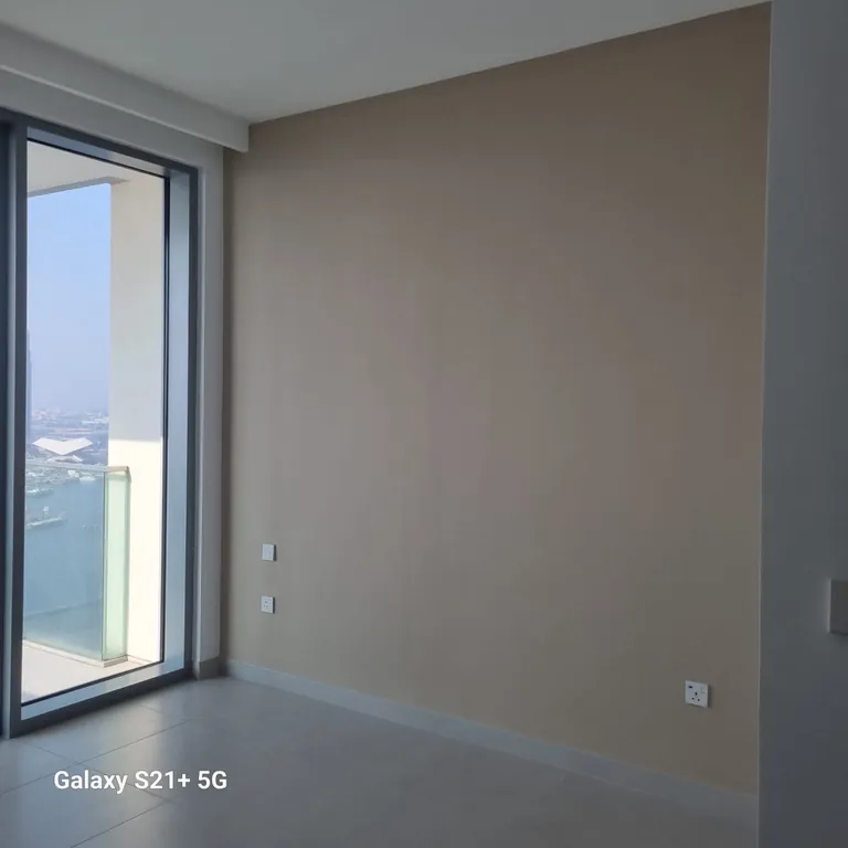 Finished neutral feature wall beside the balcony doors in the Dubai Creek Harbour apartment