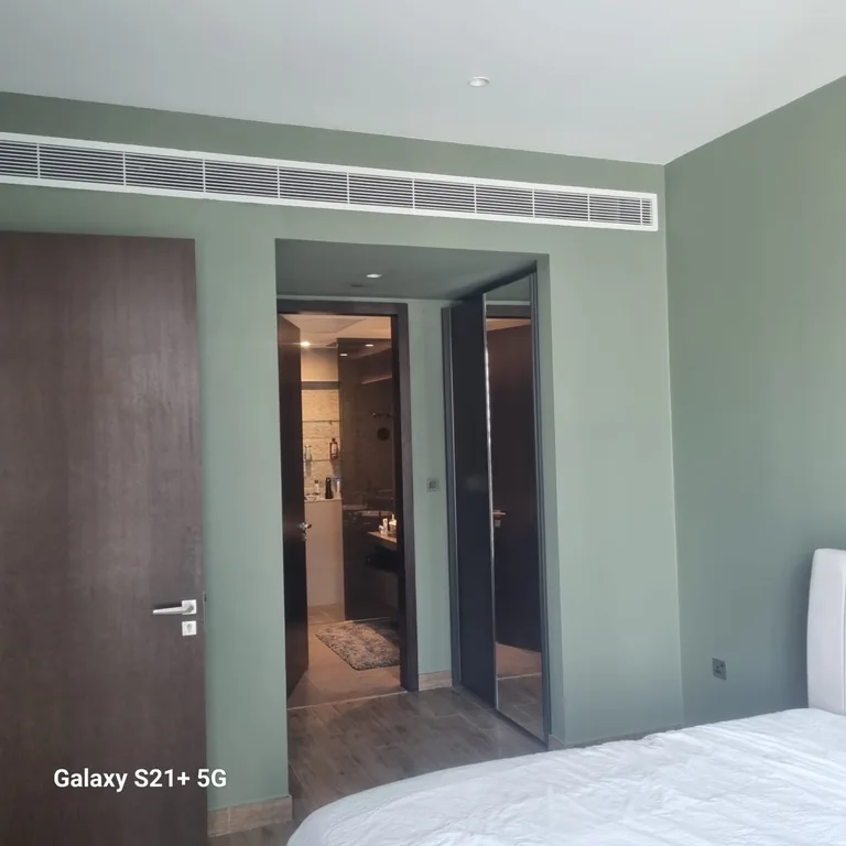 Green painted walls around the bedroom doorway after wall painting in Jumeirah Beach Residence