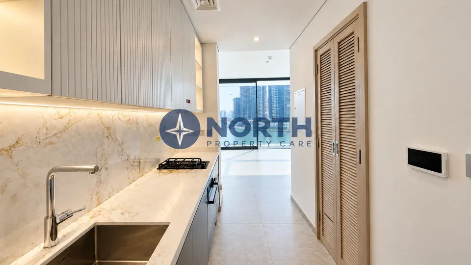 Kitchen facing living area after same-colour internal wall painting at Peninsula Four