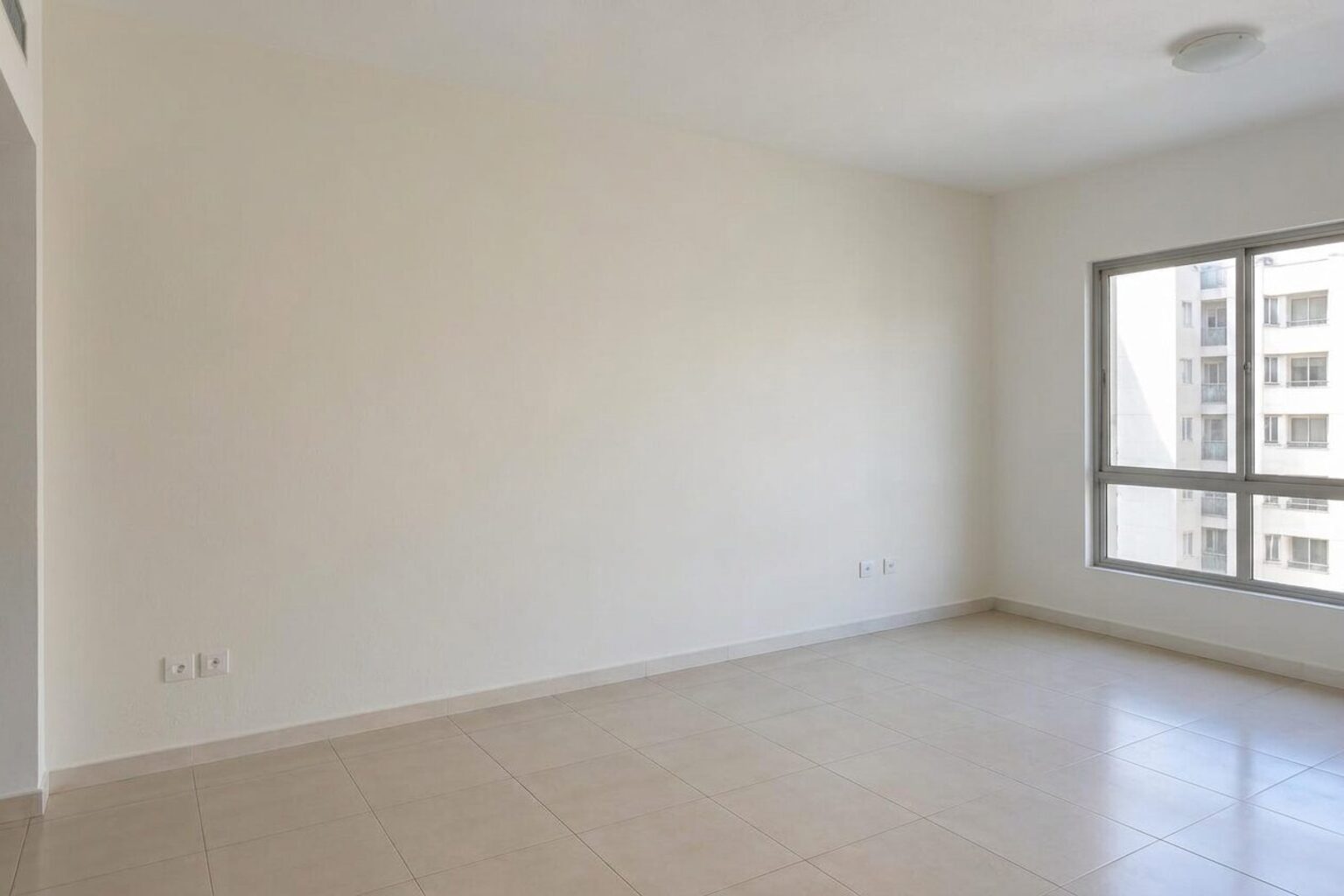 The same interior room after the wall was prepared and repainted in a clean neutral colour
