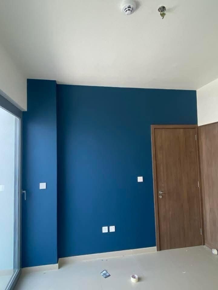 Completed dark-blue feature wall painted in a Dubai home