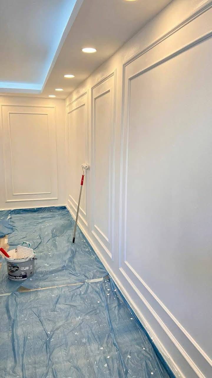 Decorative white wall painting with protected flooring in a Dubai home