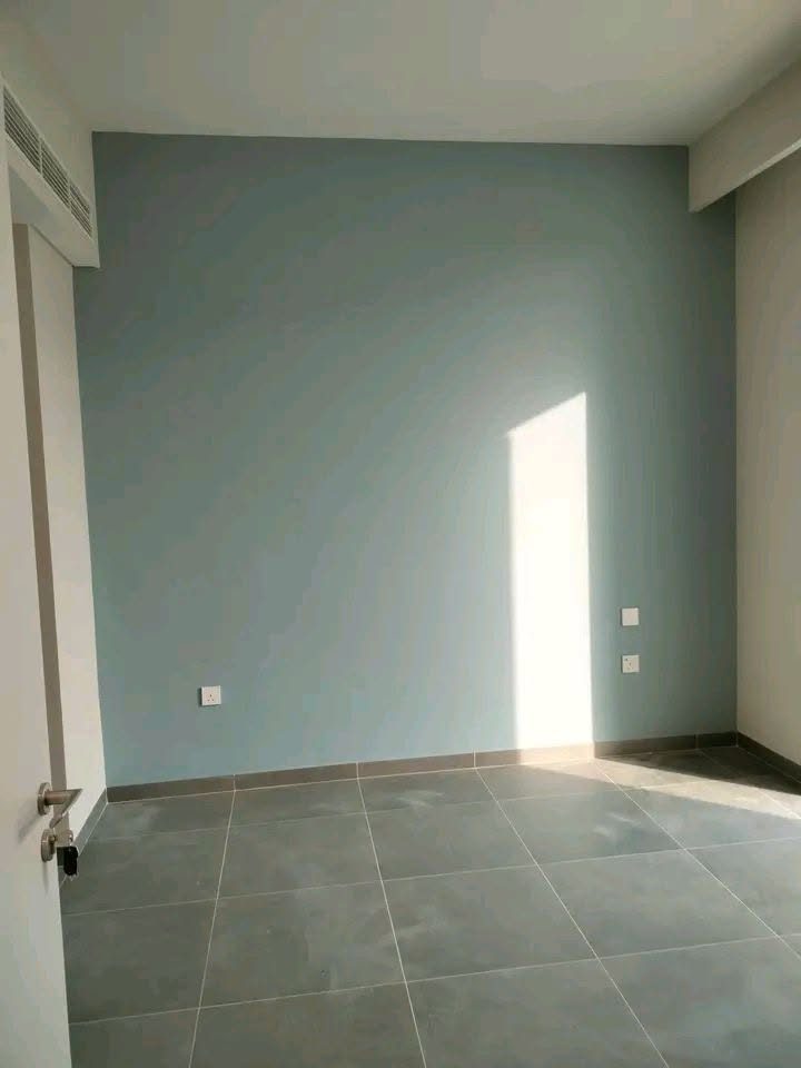 Completed light blue-green feature wall painted in a Dubai home