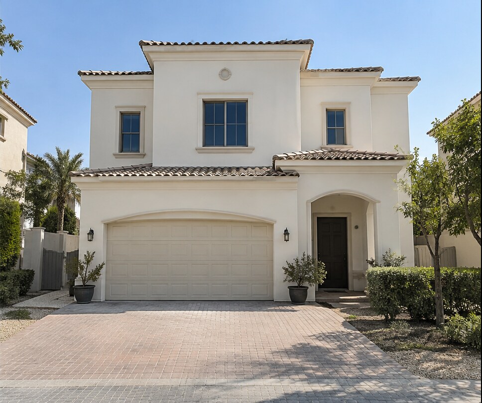 Same villa exterior after repainting with a fresh white finish