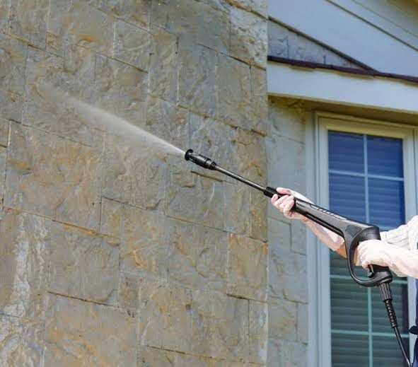 Villa exterior stone wall being pressure cleaned in Dubai